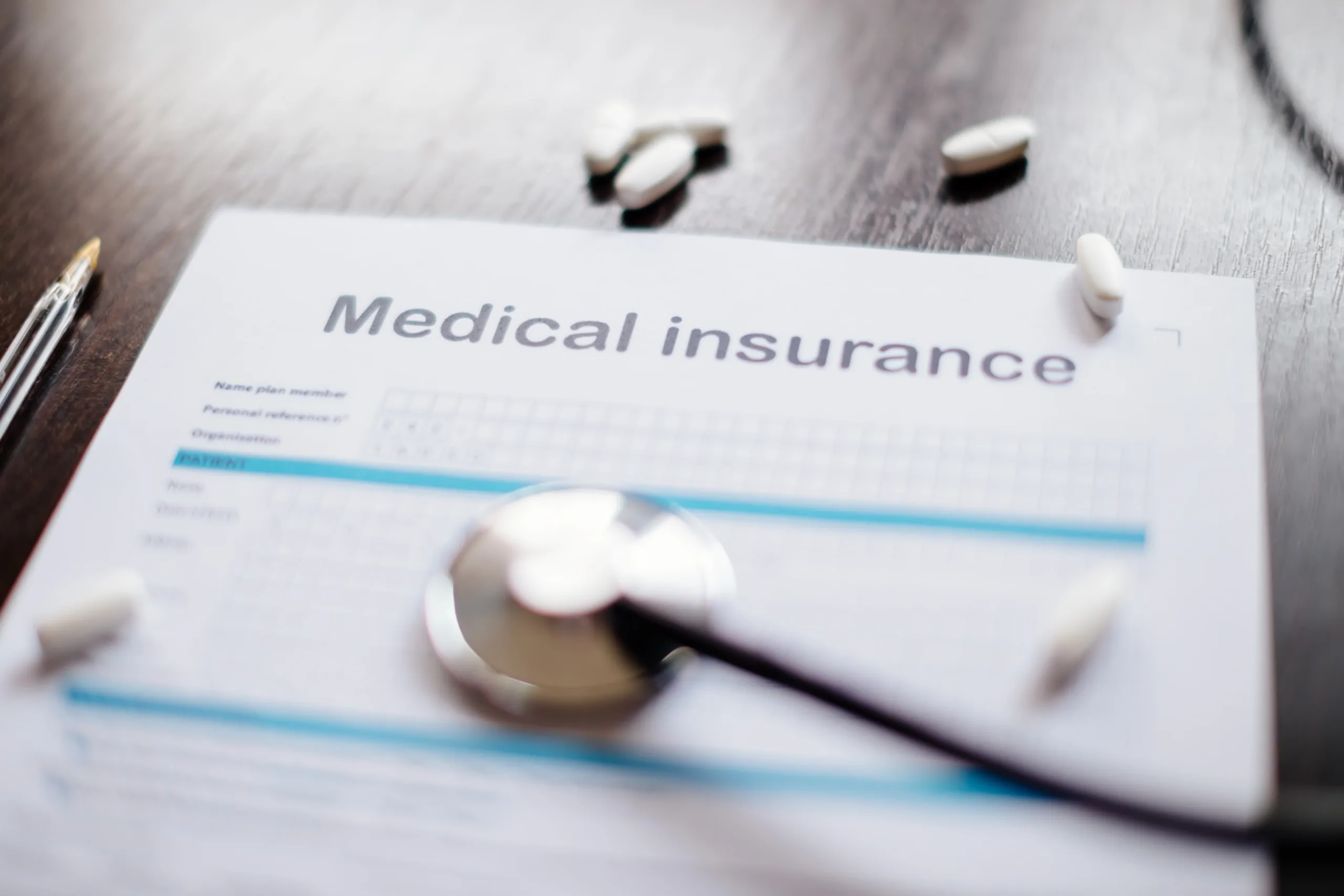 medical insurance background. Stethoscope and health insurance form. claim form.